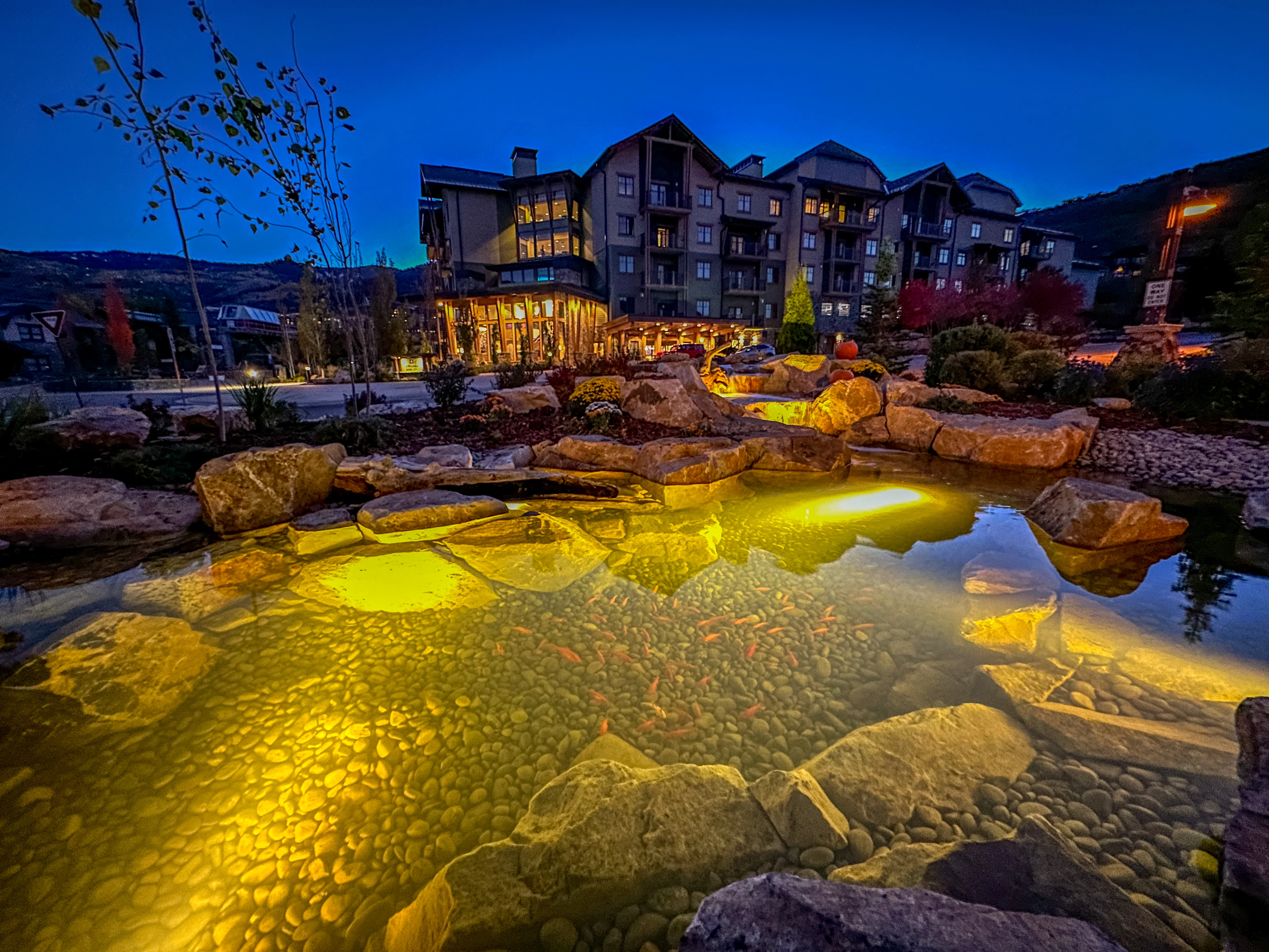 Nighttime pond lighting with glowing water and stonework in Apple Valley Minnesota
