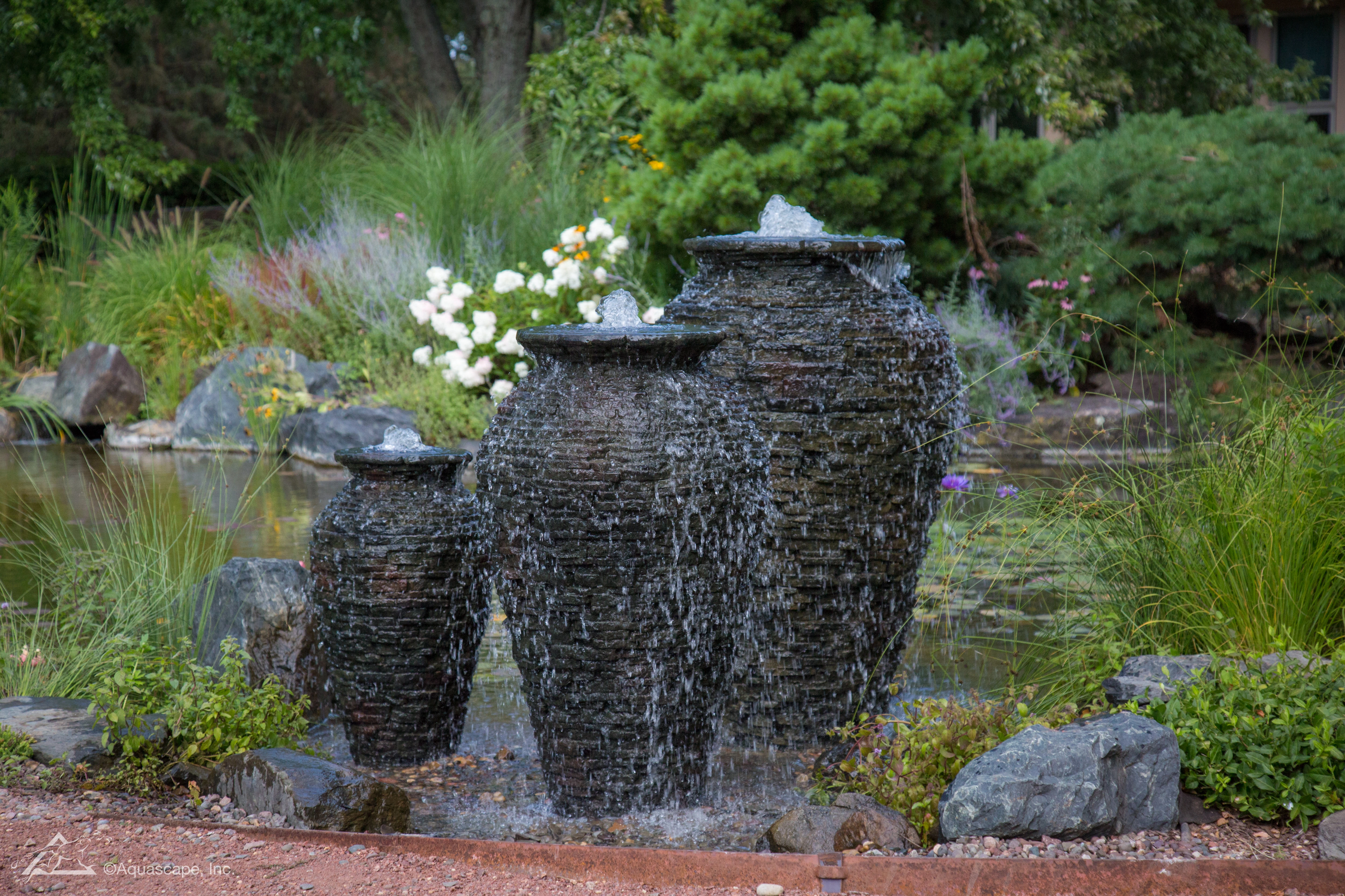 Backyard fountainscape with decorative water movement and natural stone setting
