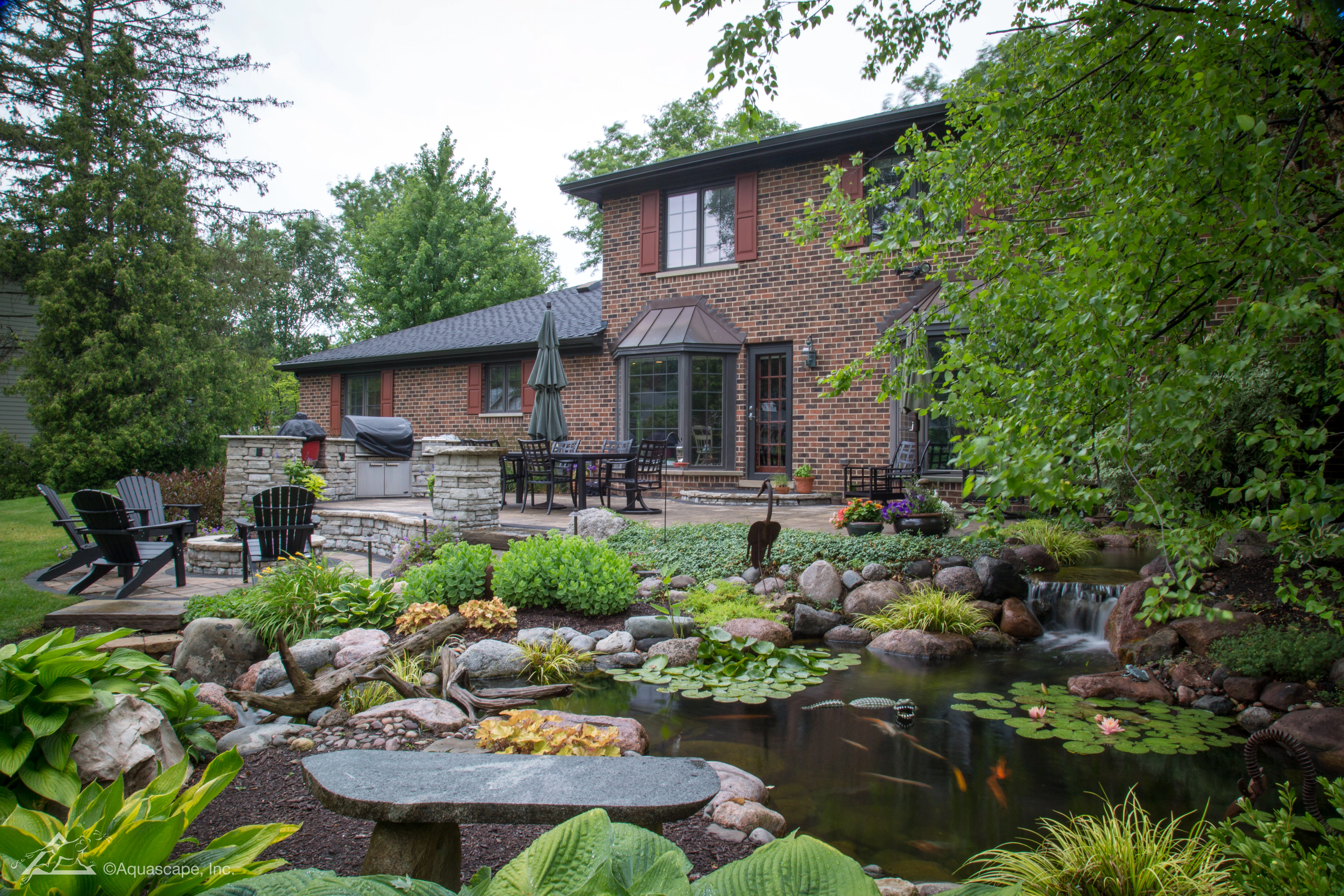 Premium backyard ecosystem pond with natural rockwork and aquatic planting