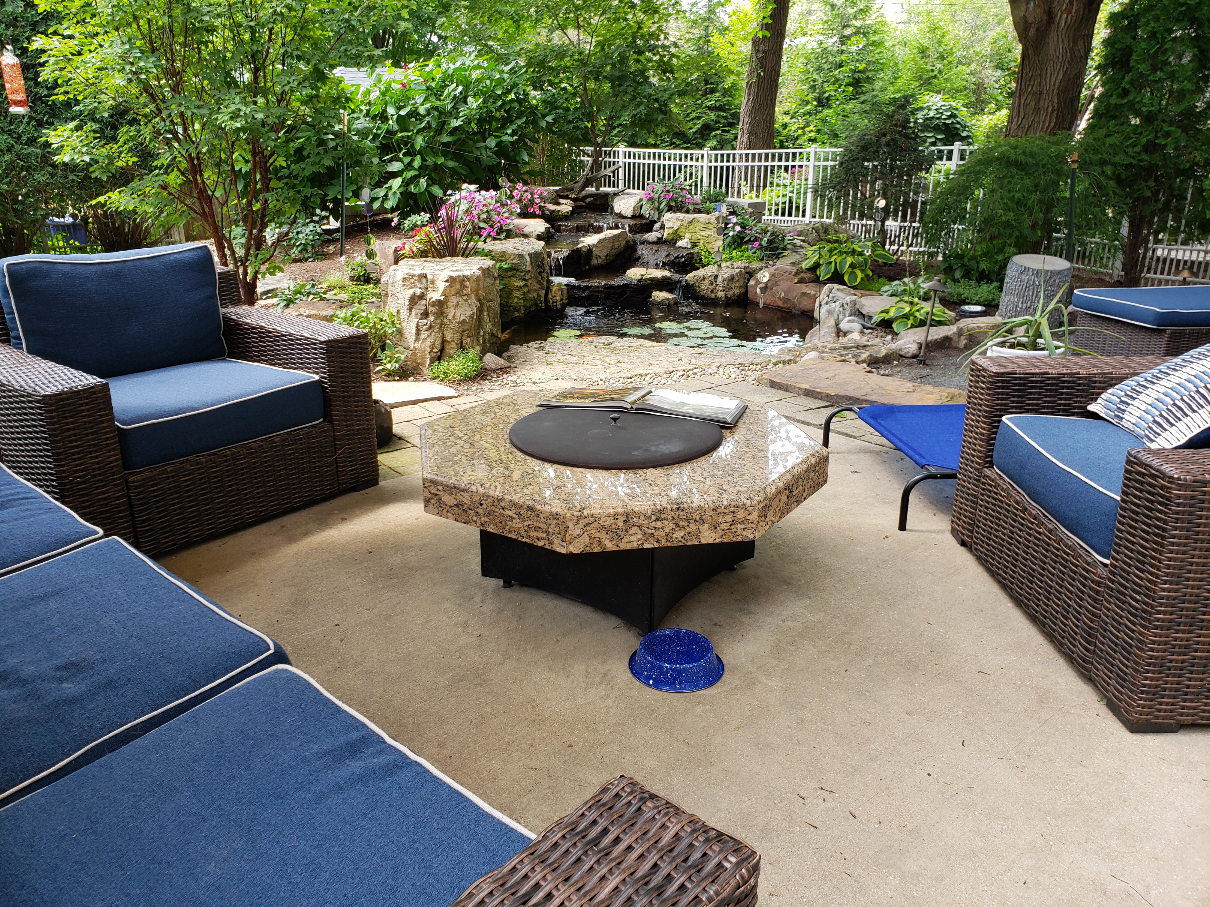 Homeowners enjoying a backyard ecosystem pond lifestyle
