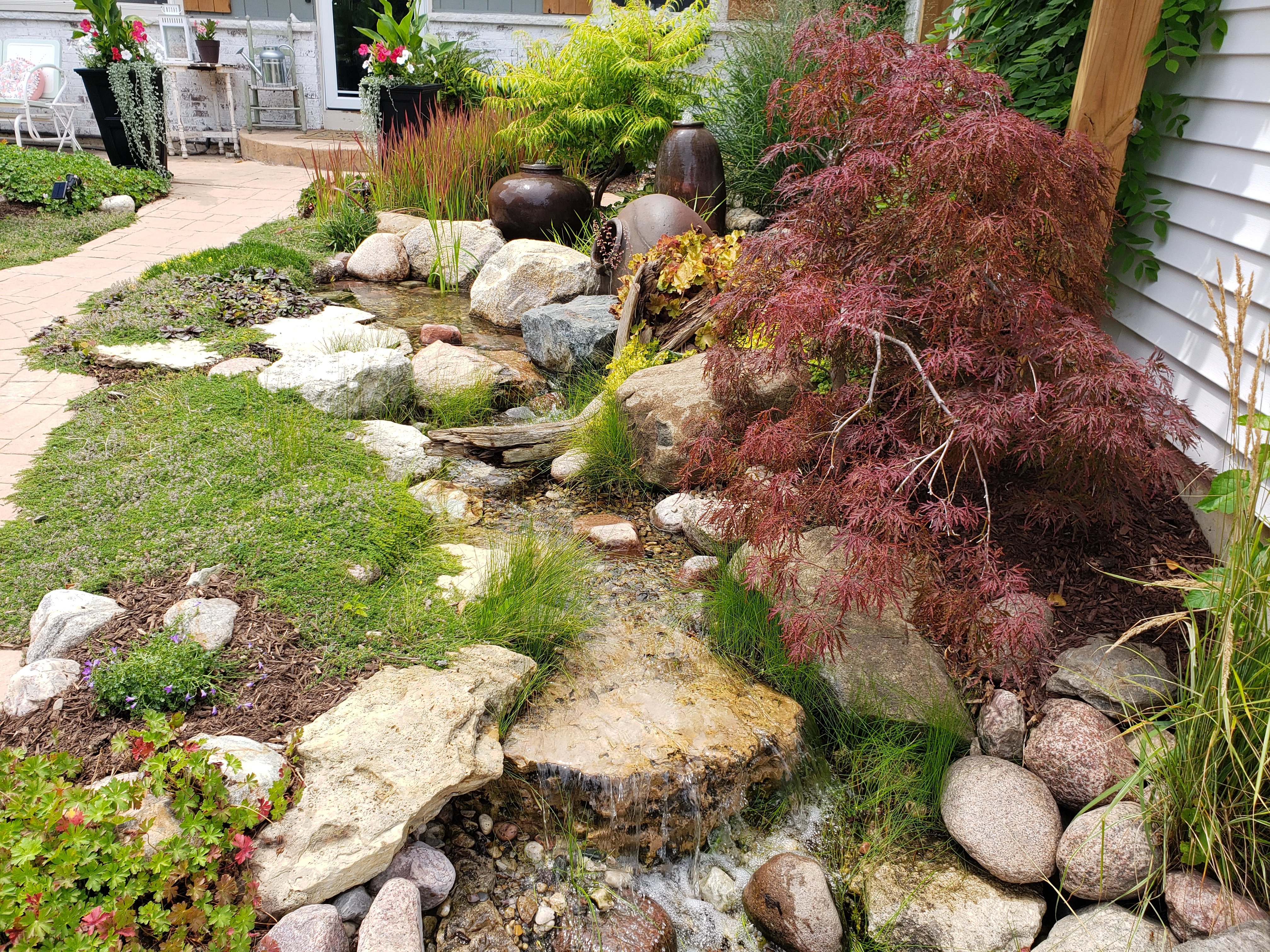 Pondless waterfall integrated near an existing retaining wall