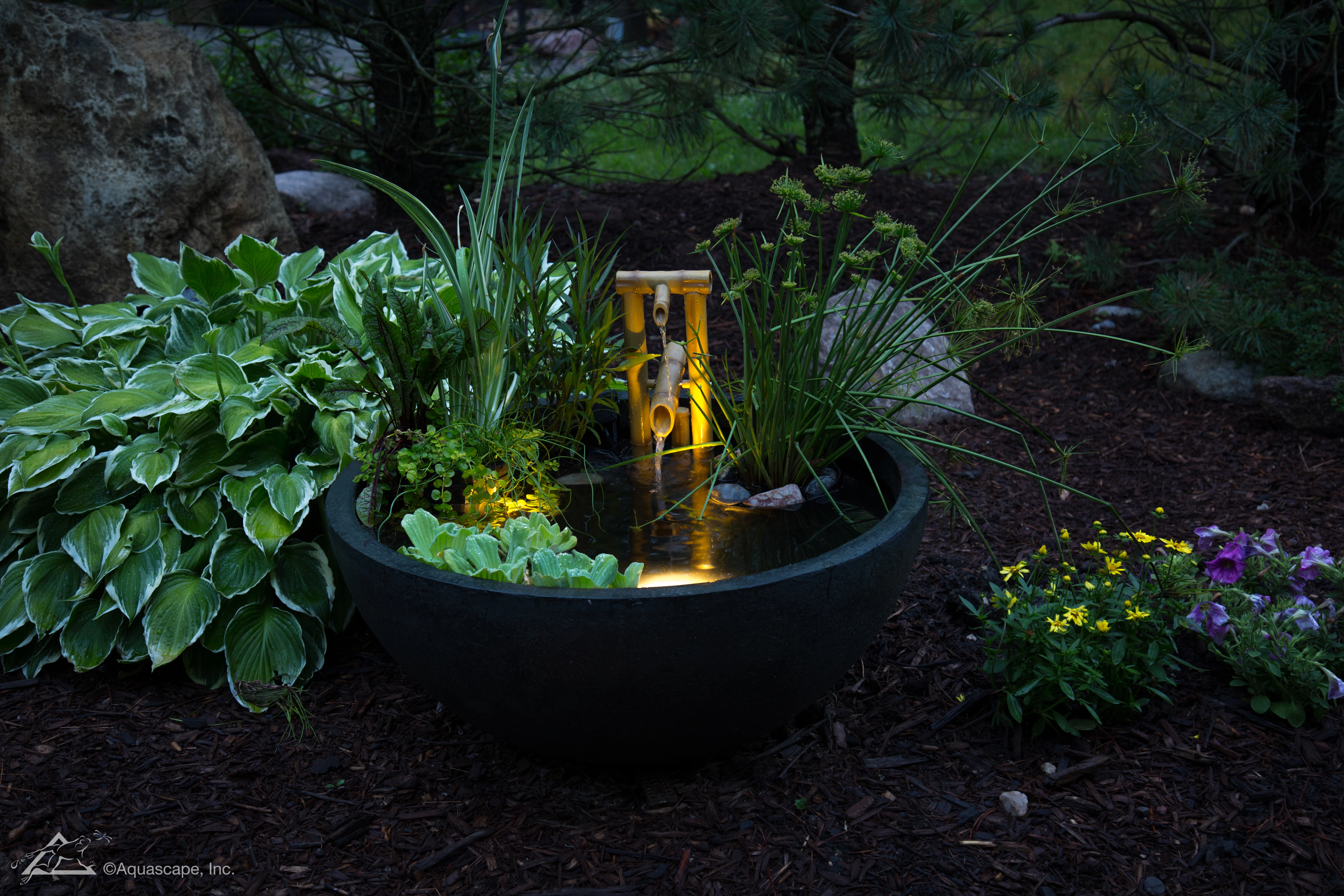Water feature beside a patio in the evening