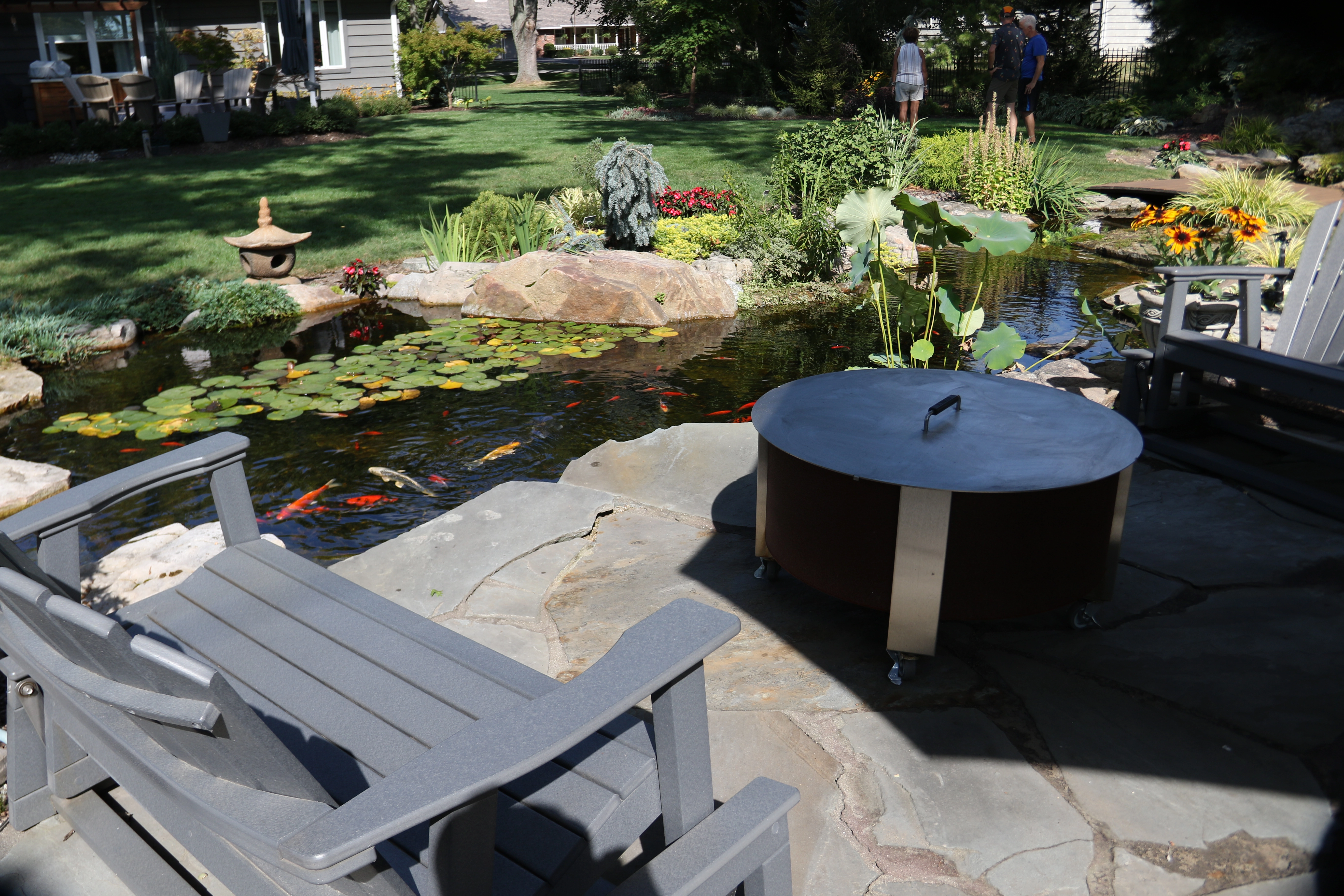 Backyard ecosystem pond beside a patio in Eagan Minnesota