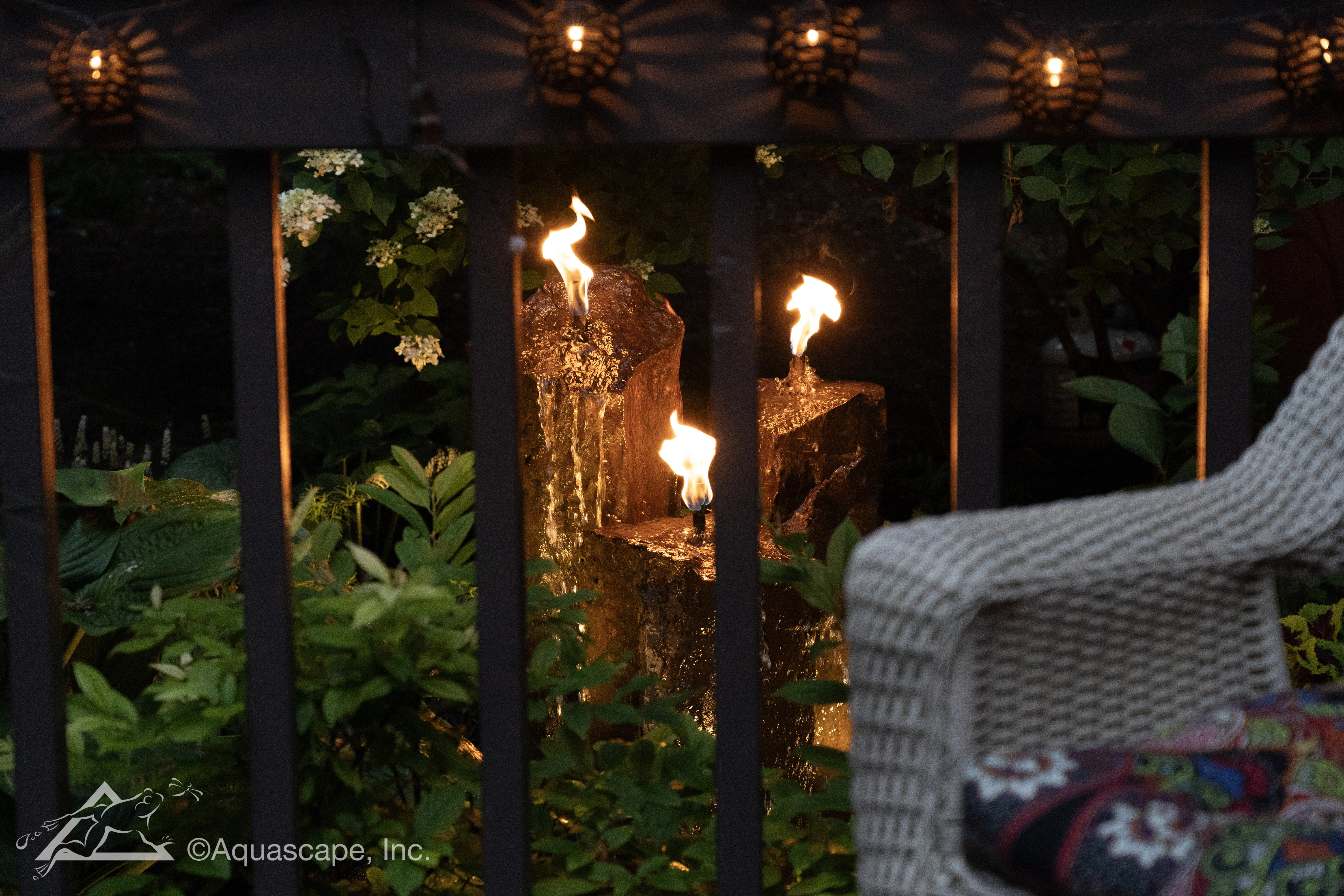 Nighttime fire and water basalt column feature for an Eden Prairie Minnesota outdoor living space