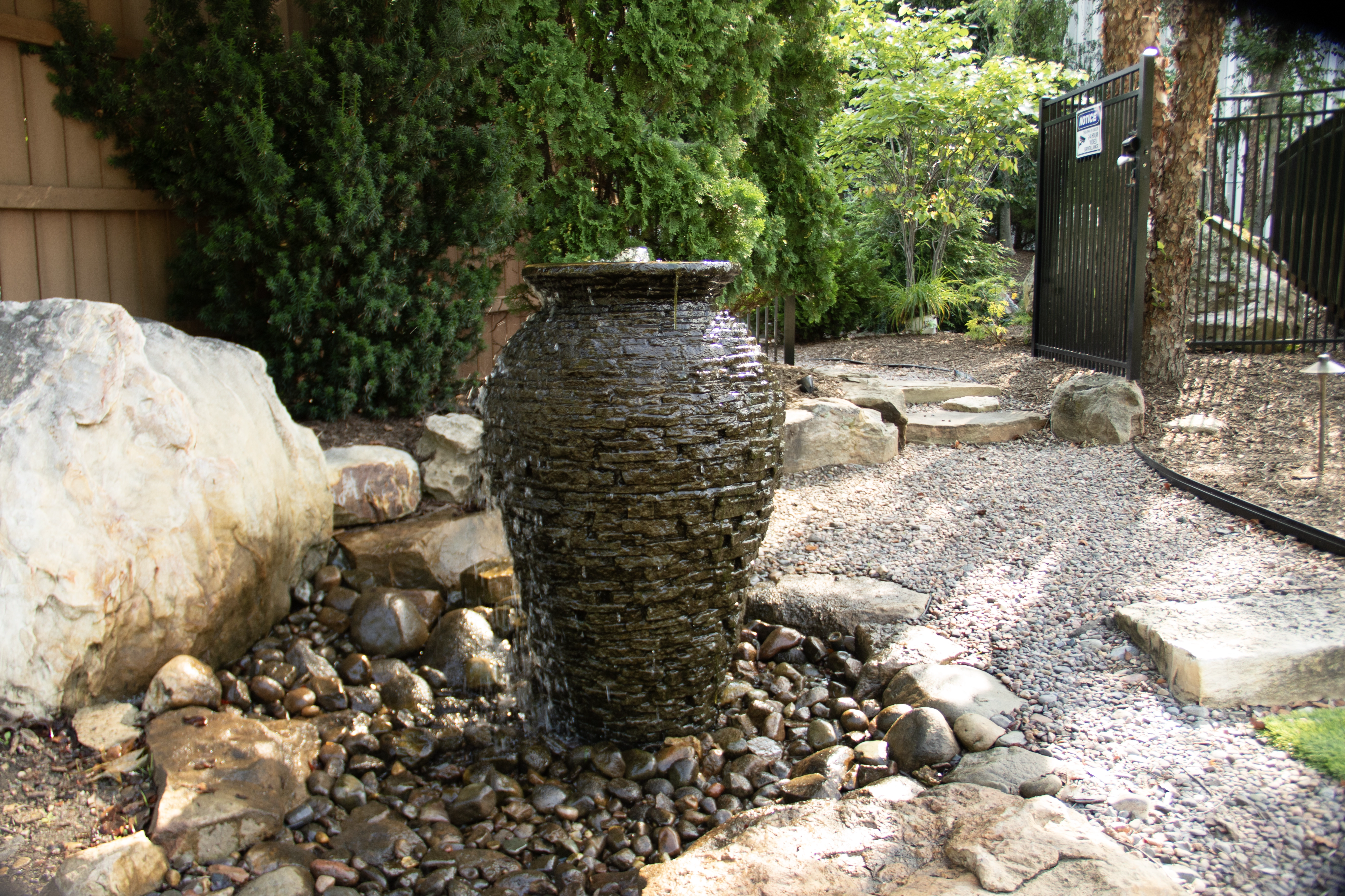 Decorative fountainscape feature in a backyard setting
