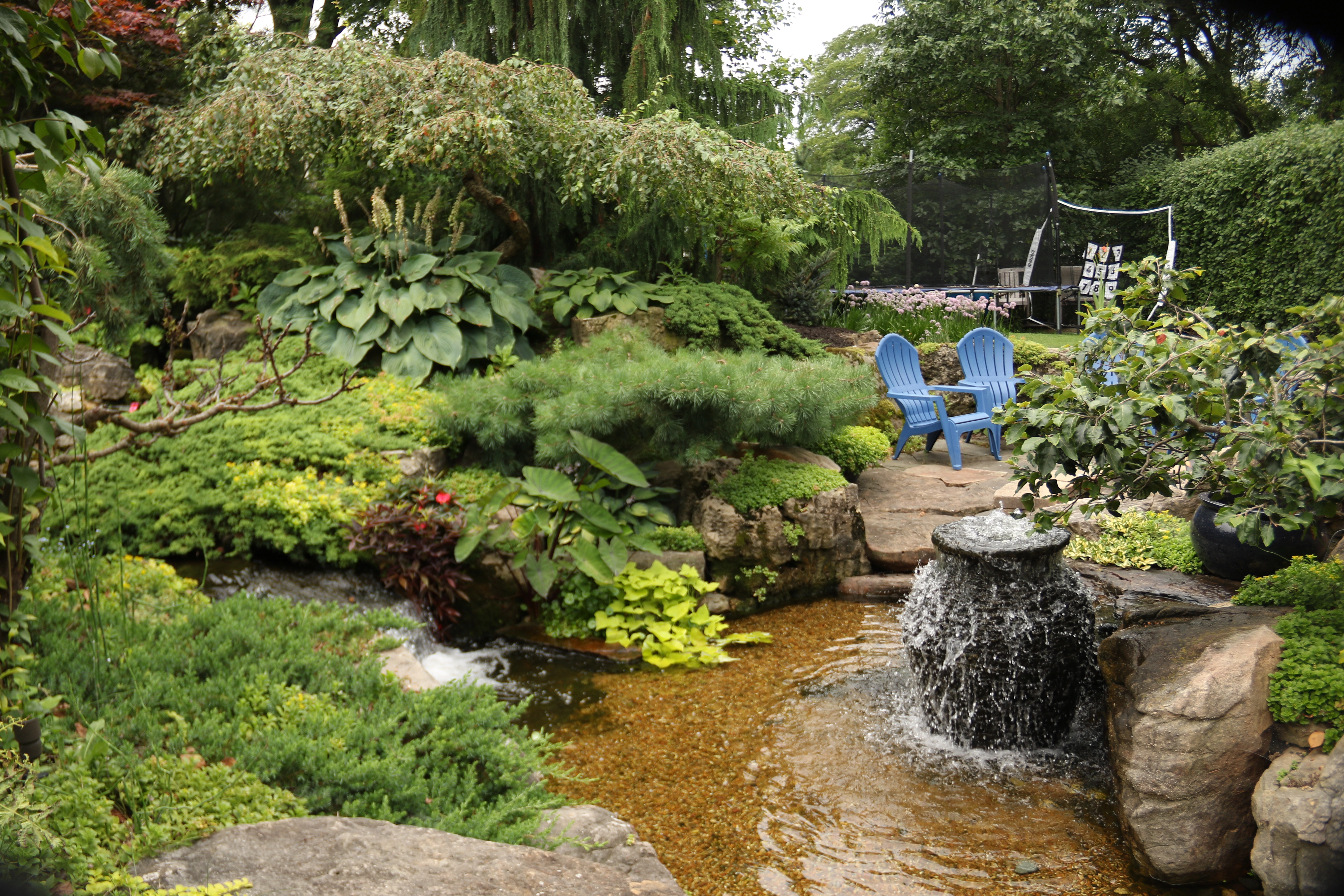 Backyard pond viewed from patio seating in Owatonna Minnesota