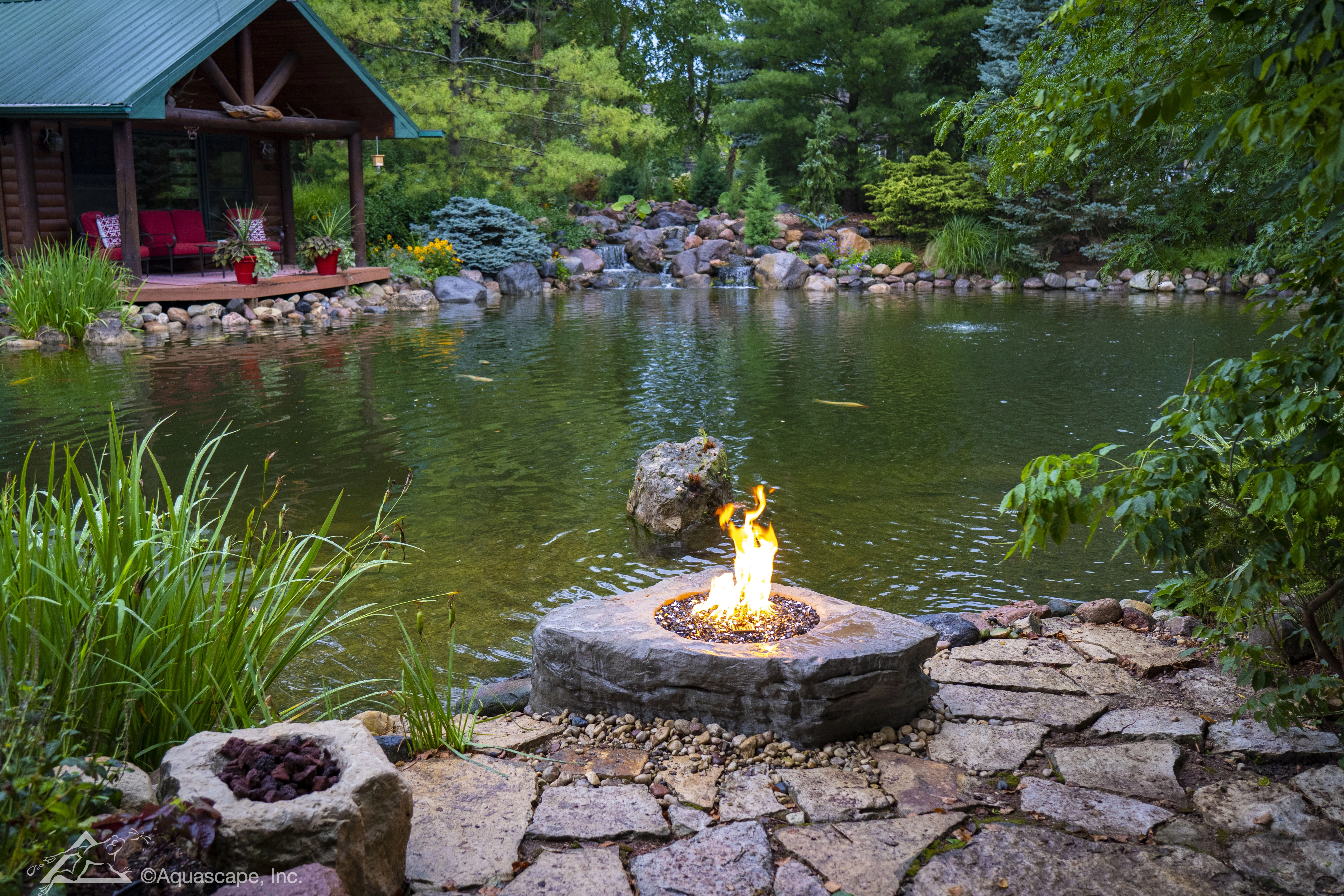 Evening firepit overlooking a custom pond and waterfall near Prior Lake Minnesota