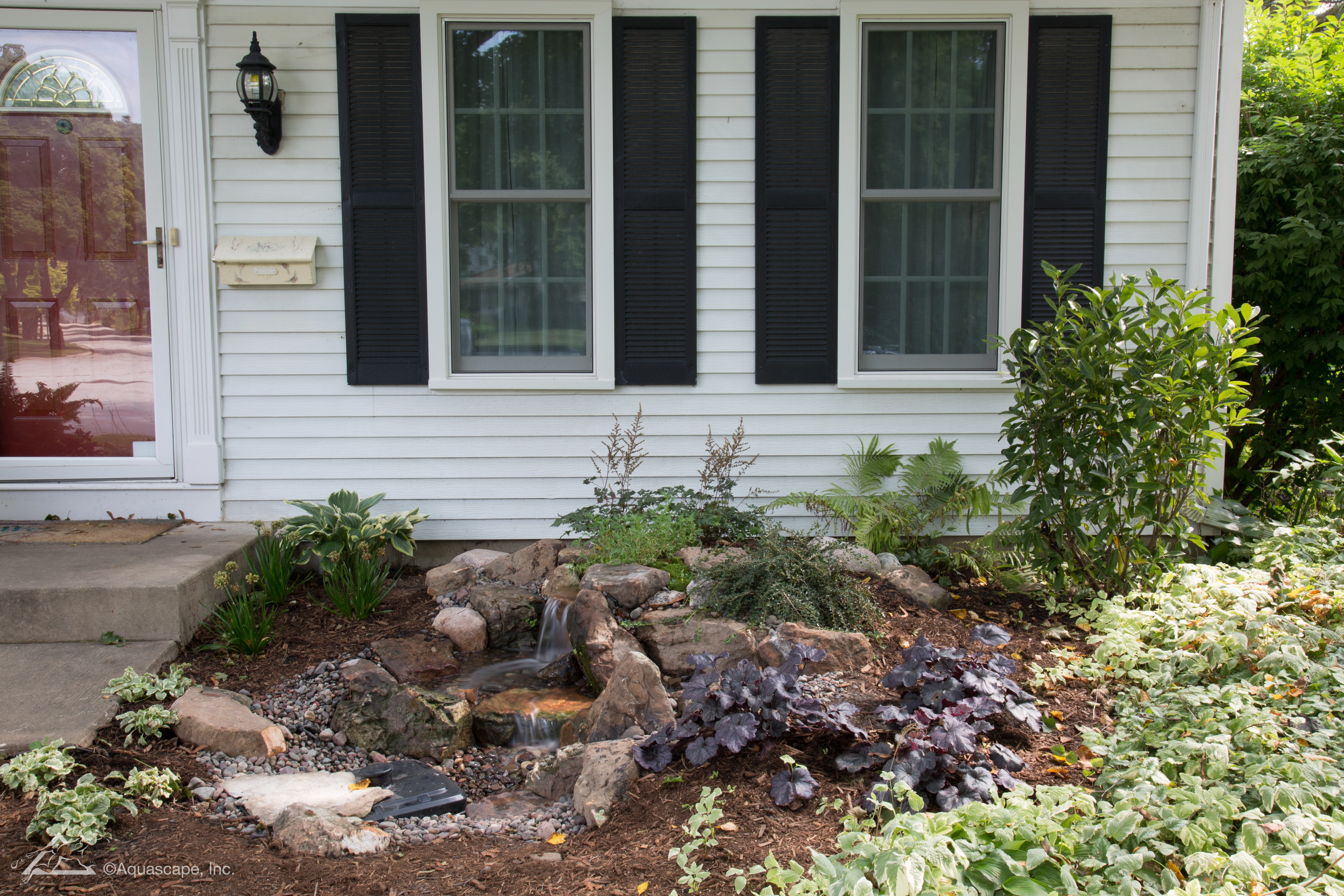Compact pondless waterfall built with natural stone