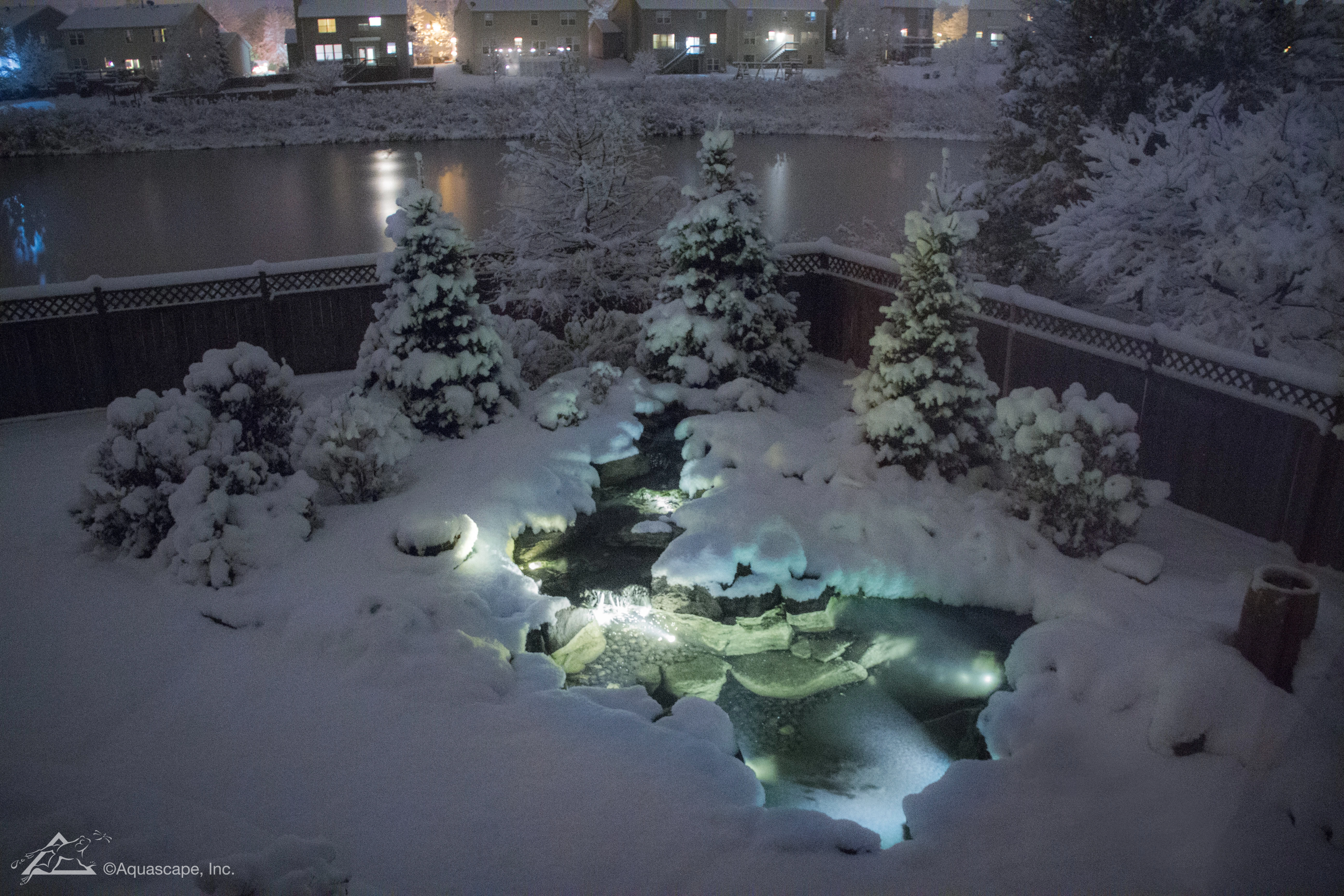 Winter nighttime lighting for a Shorewood Minnesota water feature