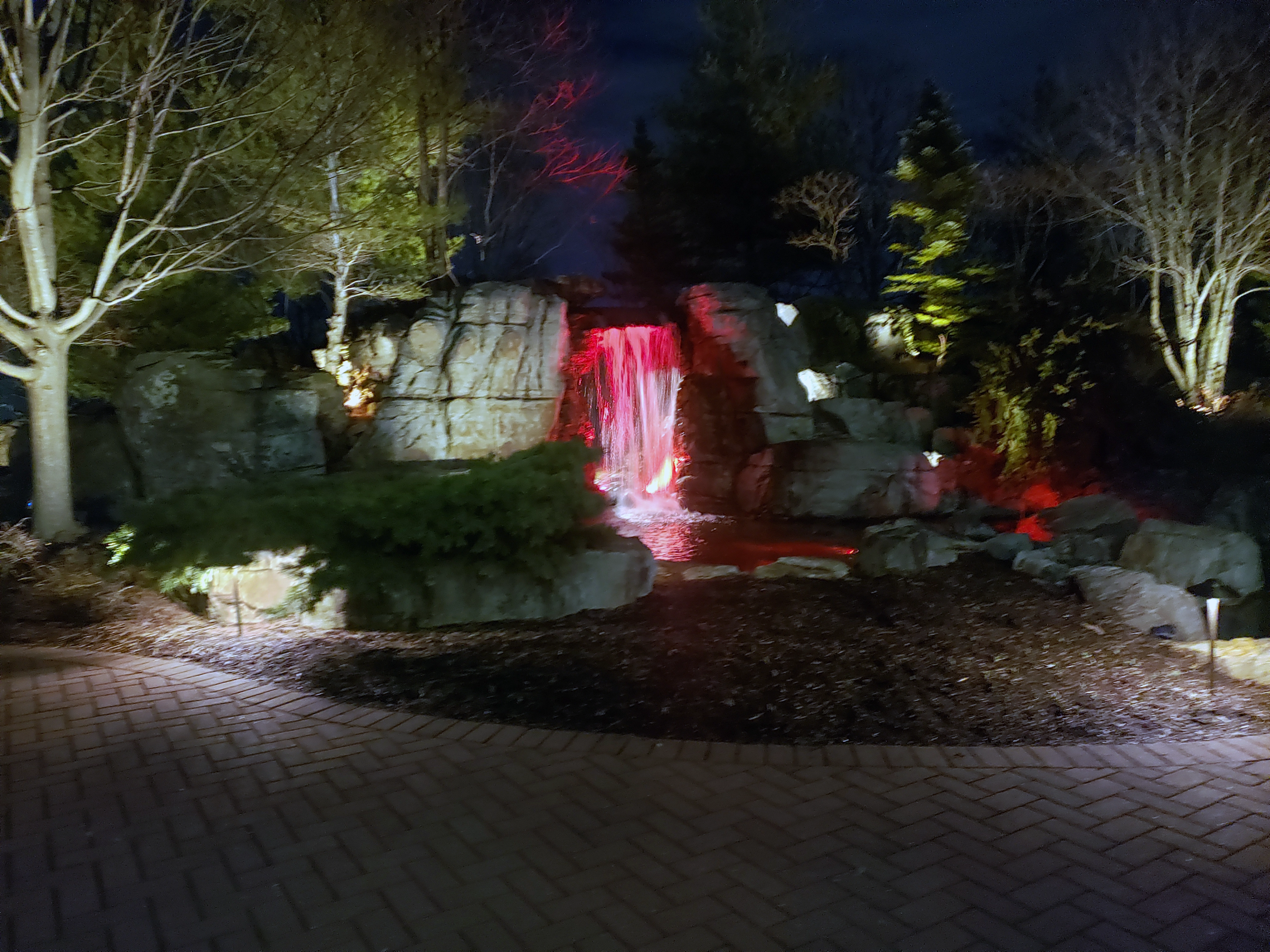 Luxury signature waterfall and ecosystem pond at dusk