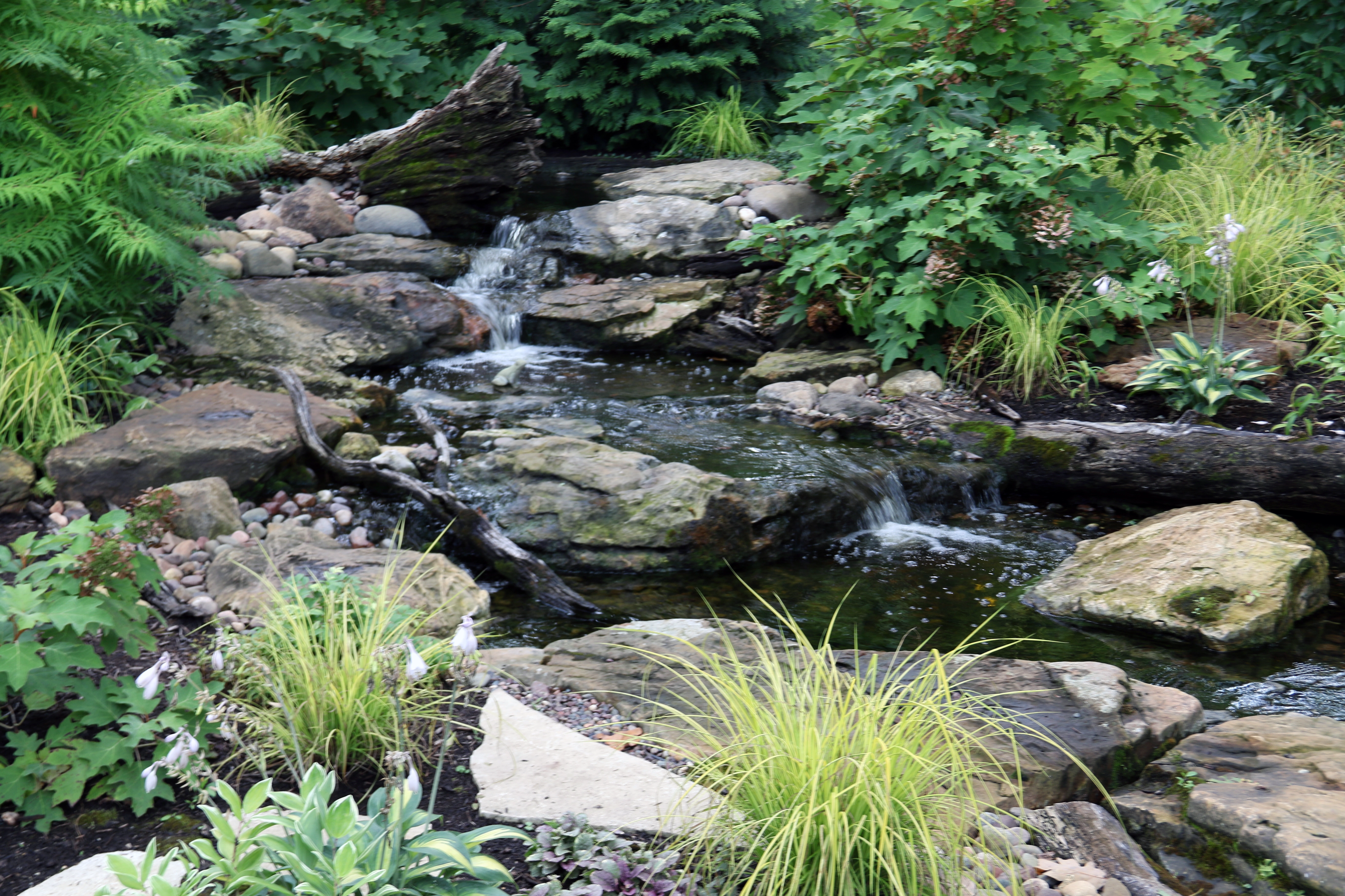 Medium-sized pondless waterfall in a suburban Minnesota backyard