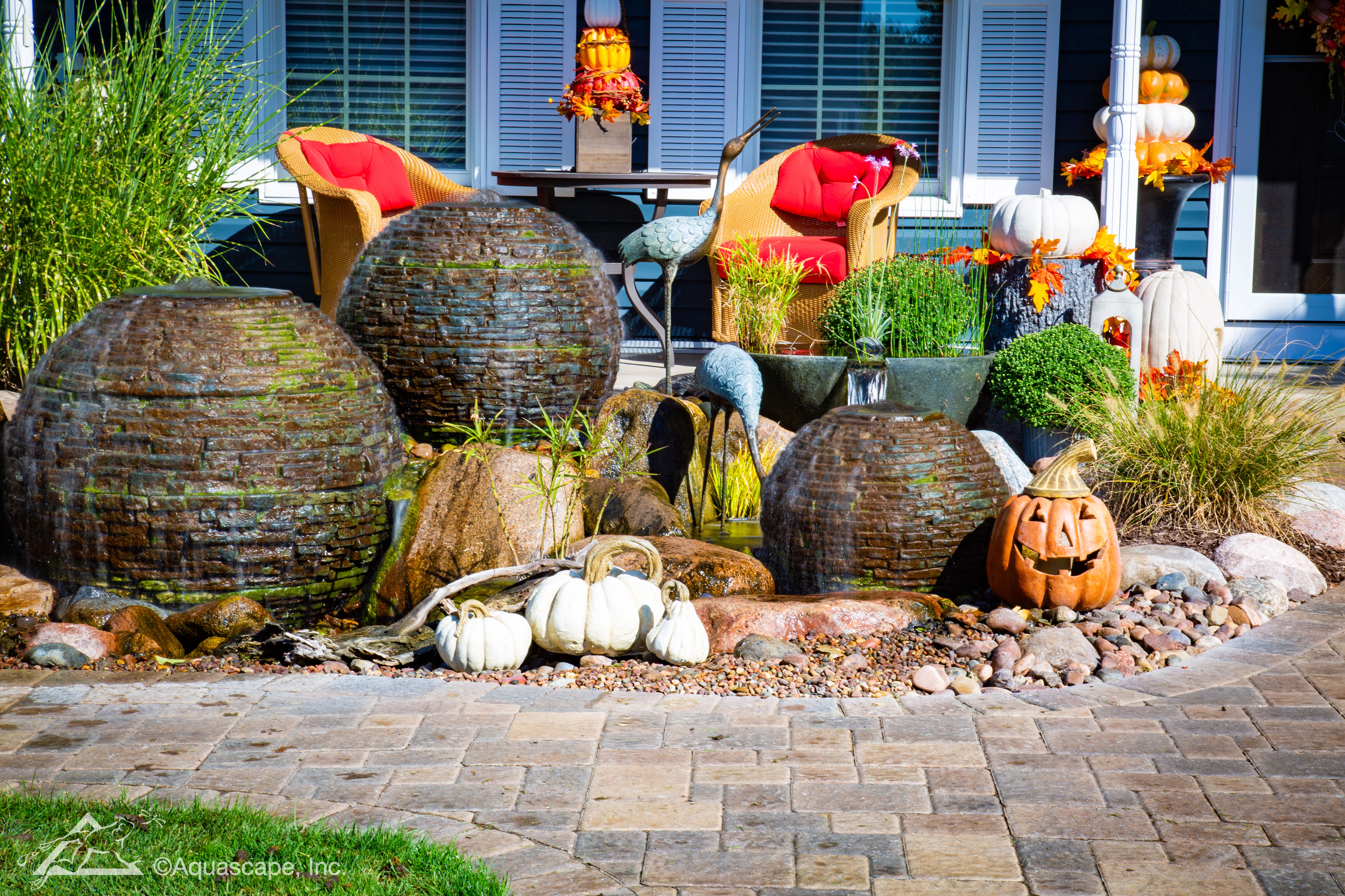 Stacked slate spheres fountainscape near an outdoor patio